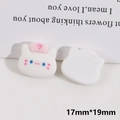 Macro view of 17x19mm flocked white puppy resin charms with pink nurse hat for DIY crafts - White Cat Head