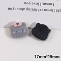 Detail showing front and back of 19mm grey cat resin patch with flocking texture - Black Cat Head