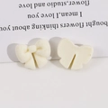 Detail view of cream white flocked resin bow accessories for DIY hair clips and crafts - Off White