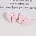 Close-up of pink flocked resin bow charms with detailed texture for DIY craft projects - Light Pink
