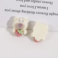 Detail view of flocked bear resin charm holding a strawberry for DIY craft and accessories - White Strawberry Bear