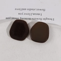 Macro detail of geometric plush resin patches for DIY hair clips in dark coffee and chocolate - Brown
