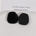 Macro detail of black trapezoid plush sponge pads with functional plastic base - Black
