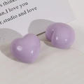 Detail of glossy lavender heart-shaped resin charms on a minimalist background - Purple Heart