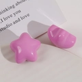 Close-up of pink glossy resin star and semi-circle DIY craft accessories for hair jewelry - Rose Red Star