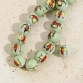 Macro detail of 12mm mint green ceramic beads with hand-painted butterfly floral patterns - 2# Green Swallow Bead / 12mm (1 Piece)