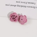 Macro view of pink flocked velvet rose charms with center holes for DIY jewelry making - Pink