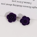 Macro shot of dark purple flocked rose earrings with velvet texture for DIY accessories - Purple