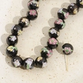 Detailed macro view of 12mm black hand-painted ceramic beads with floral patterns and pins - 5# Black Small Flower Bead / 12mm (1 Piece)