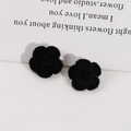 Detailed close-up of sweet black flocked rose flower patches for DIY hair accessories - Black