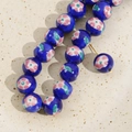 Macro detail of 12mm blue ceramic beads with hand-painted pink floral patterns - 6# Blue Small Flower Bead Variant / 12mm (1 Piece)