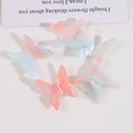 Vue à plat de barrettes papillon effet marbre dégradé rose et bleu sur fond blanc - Petit / Rouge et Bleu