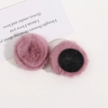 Detail of soft 4cm dusty pink plush pom-poms with black felt backing for DIY crafts - Pink Purple