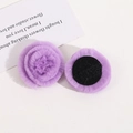 Close-up of lavender faux fur rose flower accessories with a black felt base for DIY - Purple