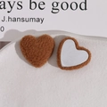 Close-up of caramel plush heart patches with metallic base for DIY hair accessories - Dark Coffee