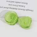 Close-up of handmade green tulle flower accessories with crystal bead for DIY crafts - Green