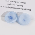 Close-up of handmade light blue sheer mesh flower petals for DIY earrings and hair jewelry - Blue