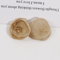 Detail of champagne mesh flowers with amber faceted beads for DIY hair accessories - Brown