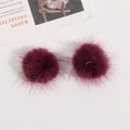 Close-up of fluffy dark burgundy faux mink fur pom poms for DIY hair accessories - Brownish Red