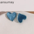 Macro shot of blue heart resin charms with pearlescent and transparent textures - Blue