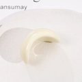 Vue macro d'un accessoire en résine blanc crème en forme de croissant poli brillant - Blanc