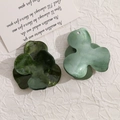 Macro detail of acrylic tri-petal flower charms with marble texture and glitter finish - Dark Green