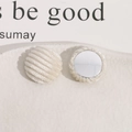Detailed view of beige corduroy round button patches with metallic center for DIY crafts - White
