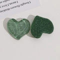 Macro detail of heart-shaped resin charms with green water ripple and bubble textures - Light Green
