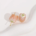 Macro view of tulip-shaped resin beads with orange-pink glitter and green calyx details - 1 Piece / Light Orange