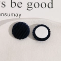 Detail shot of navy blue velvet round buttons for DIY jewelry with striped plush texture - Black