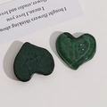 Detail of dark green heart-shaped resin charms with marble and translucent wave effects - Dark Green