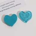Macro detail of wave-textured translucent heart resin charms in cyan and blue - Sky Blue