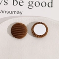 Macro view of brown corduroy round DIY accessory with a flat white base and soft texture - Brown
