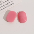 Close-up of pink oval resin cabochons for DIY jewelry making on a minimalist background - Pink