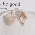 Close-up of handmade diamond-shaped pendant with gold wire and clear crystal beads - Geometric