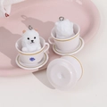 Macro view of white teacup pomeranian figurine with crown detail and metal hanging ring - White