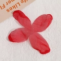 Macro view of red mesh four-petal flower craft accessory for DIY earrings and hair jewelry - Red