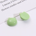 Detail view of light green cat-shaped resin charms for DIY earrings and hair accessories - Green