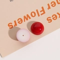 Detail of 18mm round resin beads in glossy red and matte pink for jewelry DIY - Red