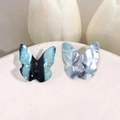 Macro view of 3D resin butterfly charms with metallic texture for DIY jewelry making - Black and Blue