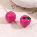 Dettaglio di perle di mela in resina rosa e accessori fai-da-te su carta bianca - Rosa Rossa