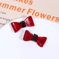 Close-up of red acetate bow hair clips with gold France Handmade lettering - Red