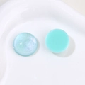 Detail of round resin charms with blue aurora pearlescent and mint green glossy finishes - Lake Green Style A