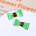 Detail of green and red acetate bow accessories with gold France Handmade lettering - Green