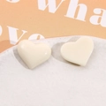Macro detail of cream-colored 3D resin heart charms with polished glossy finish - Milky White