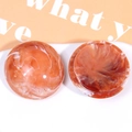 Macro detail of oversized resin patches with marble smoke pattern for DIY phone grips - Orange Brown