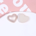 Detail view of champagne faux pearl heart charms with glossy front and matte white back - Rose Gold