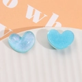 Detailed view of blue heart resin charms with glitter texture for DIY hair accessories - Blue