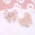 Close-up of pink translucent resin bow charms for DIY jewelry and hair accessories - Light Pink
