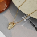 Golden flip-flop pendant necklace with white crystals on a fashion magazine background - Gold - Flip Flop Necklace
